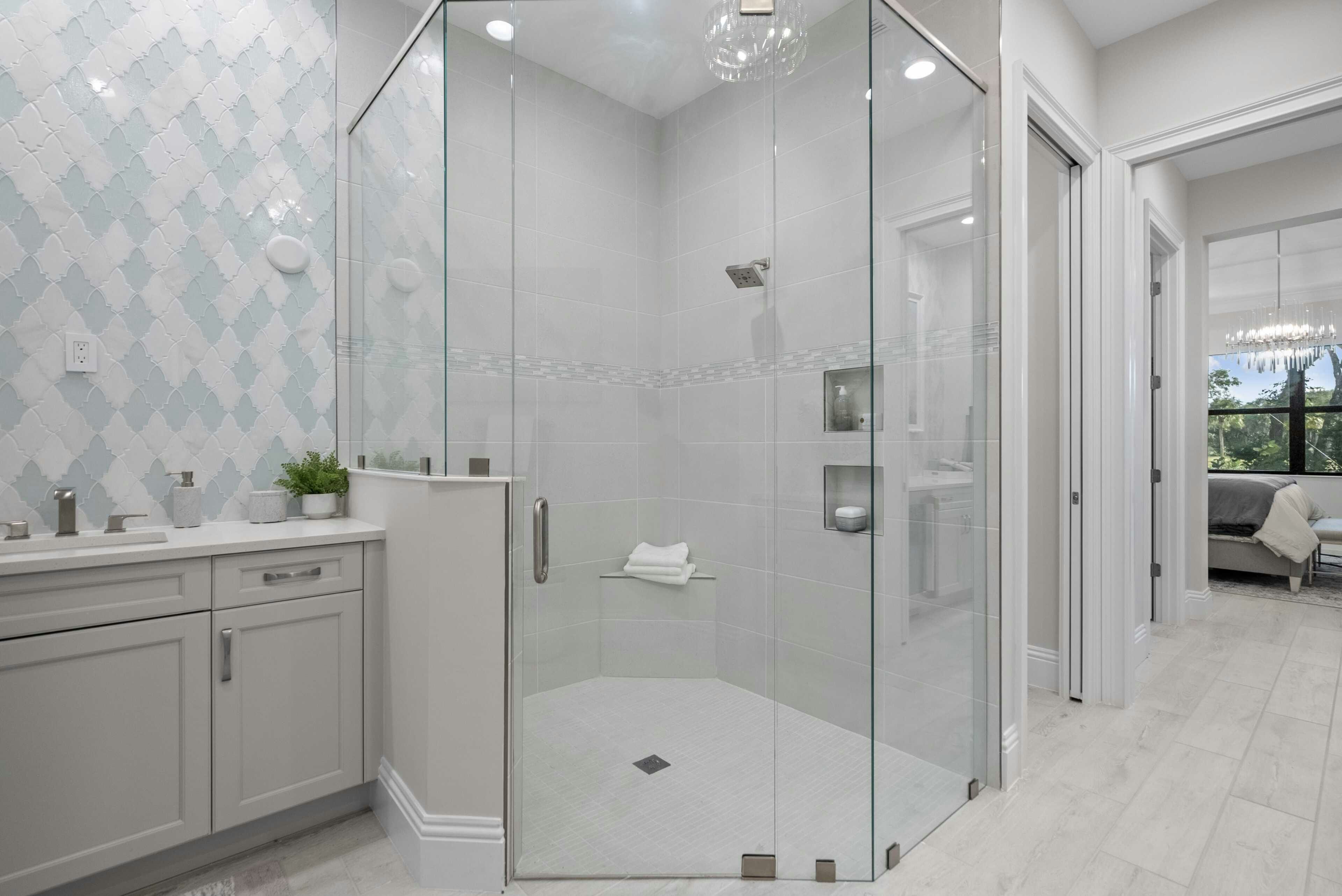 Master bath corner shower in white and grey colors