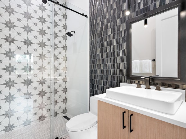 Secondary Bath | Keenan Model Mosaic black wall detail in a secondary bath