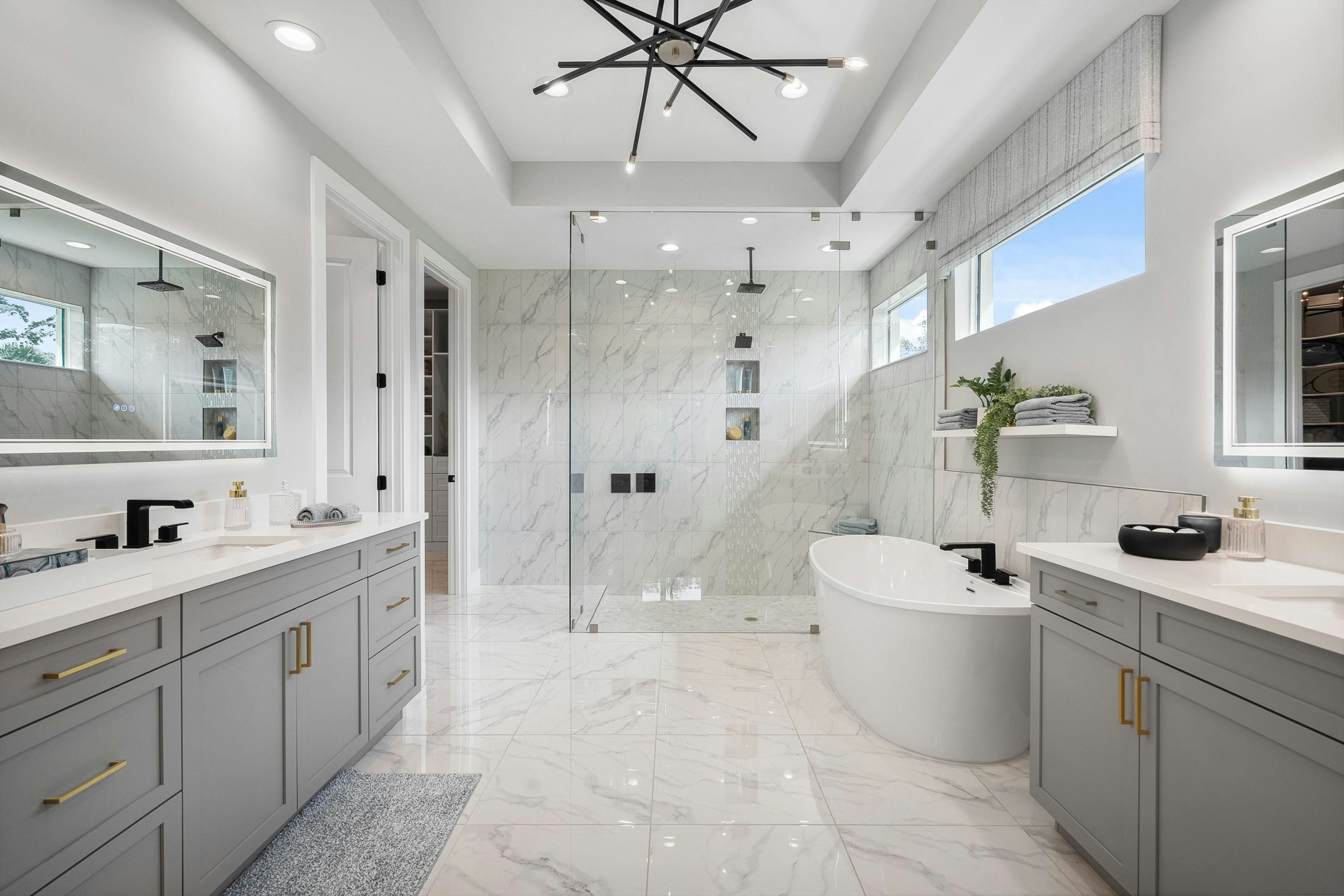 Master bath with porcelain tile on floor and in shower, LED mirrors and ovel modern soaker tub