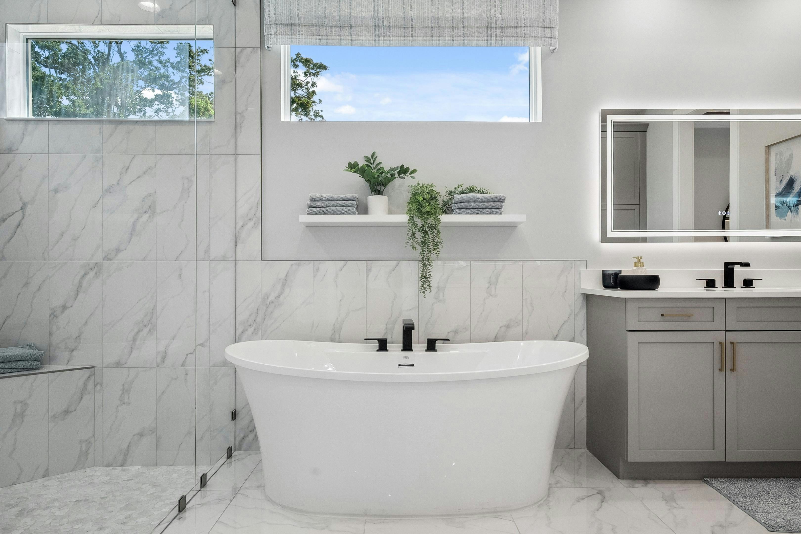 Master bath with modern soaker tube, vertical installed tile on wall and in shower