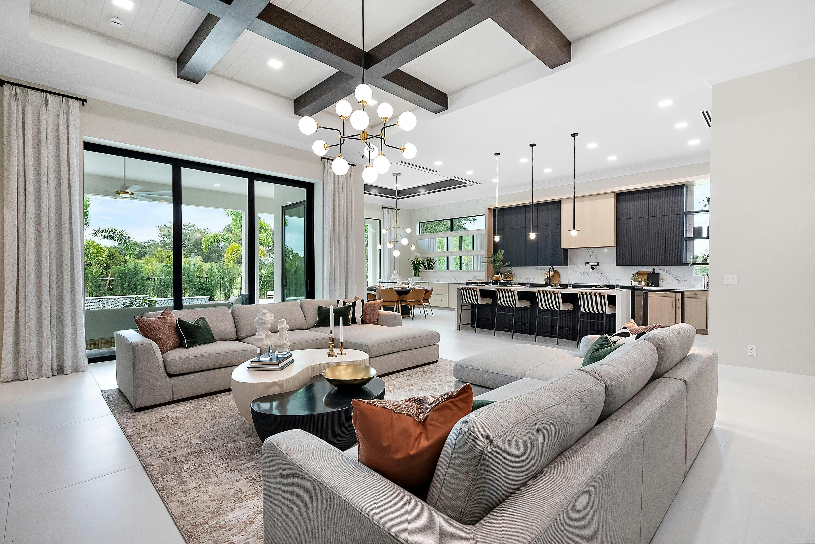 Great room with black box beams looking to kitchen modern black cabinets