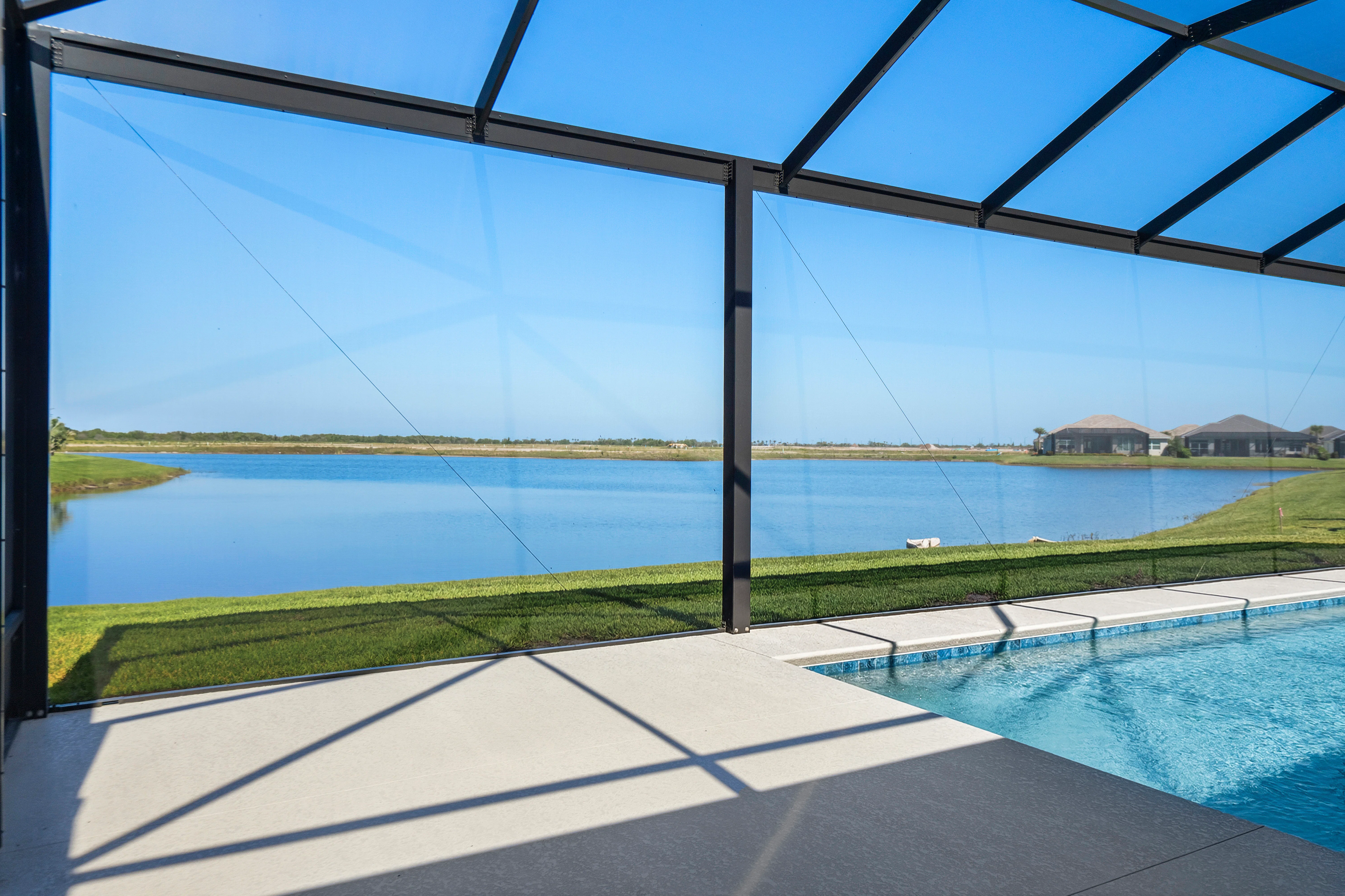 Screened Pool Decking and Backyard View | 14322 SW Belterra Drive